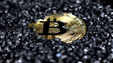 Close-up of a bitcoin coin on a black surface